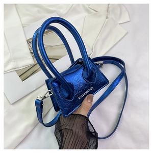 Close-up of metallic blue micro bag with crinkled texture and silver logo detail