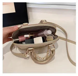 Top view of champagne gold shell bag interior showing storage for cosmetics and accessories