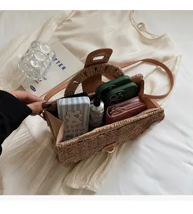 Interior view of straw woven bag showing large capacity for phone, wallet and cosmetics