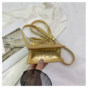 Macro view of metallic gold pleated faux leather texture and white logo on mini bag