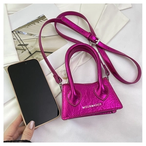 Mini metallic purple crossbody bag shown next to a smartphone for size comparison