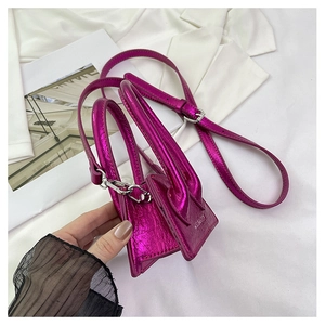 Close-up of mini metallic purple handbag with dual handles and silver hardware detail