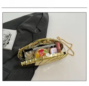 Top view of gold acrylic evening bag showing capacity for phone and cosmetics