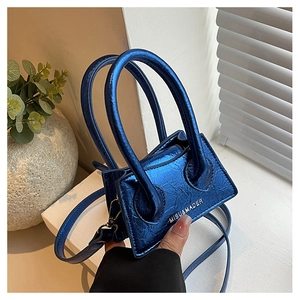 Detail of blue metallic textured mini handbag with silver logo and adjustable strap