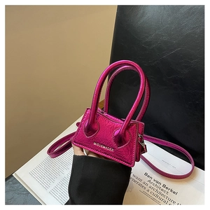 Macro detail of metallic fuchsia mini crossbody bag with wrinkled leather texture