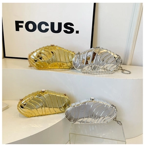 Detail of evening clutch bags with ripple texture and metallic gold silver finish