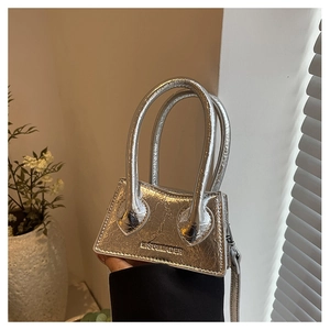 Close-up of silver mini handbag showing metallic faux leather texture and round handles