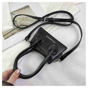 Top view of mini black glossy wrinkled PU leather handbag with adjustable strap and dual handles