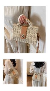 Detail of hand-woven straw bag with premium brown leather trim and metal clasp