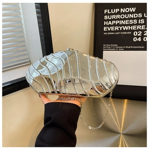 Chic silver seashell-shaped evening clutch bag with metallic wavy texture and chain