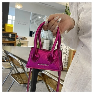 Detail of a mini purple PU leather square bag with crushed texture and silver MISU lettering