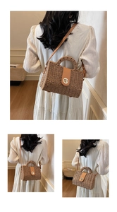 Detail showing the brown leather flap and metal turn-lock on the woven straw handbag