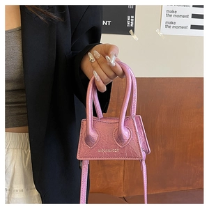 Pink patent leather mini handbag with top handles and adjustable long shoulder strap