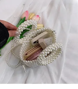 Detailed view of white pearl woven bag interior showing spacious storage for essentials