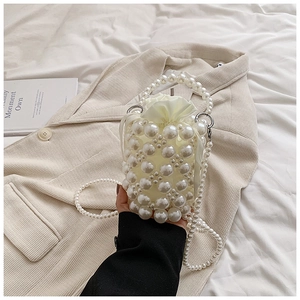 Detailed view of handmade pearl woven bucket bag with elegant drawstring inner pouch