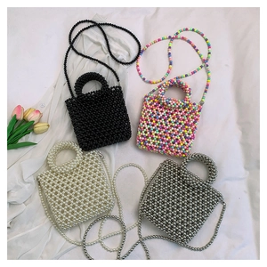 Flat lay of four colorful mini beaded jelly handbags with elegant flower accents