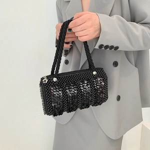 Elegant black sequin pearl handbag with woven handles and silver flower pendant detail