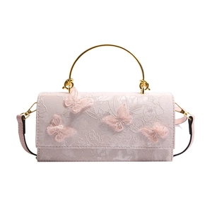 Pink lace crossbody bag with butterfly embroidery and golden metal ring handle