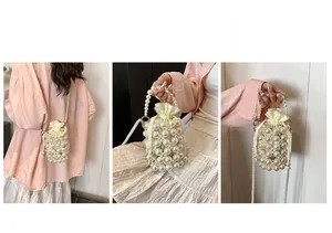 Detail of beaded pearl bucket bag with drawstring pouch and versatile shoulder strap