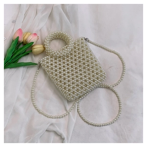 Exquisite handmade ivory pearl woven handbag with top handle and floral tulip accents