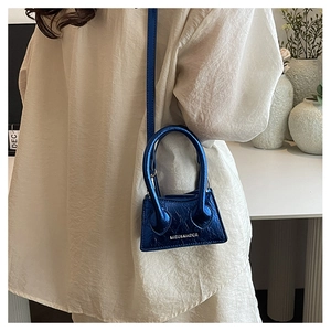 Detail of metallic blue mini bag featuring crinkled leather texture and MISU&MADER logo