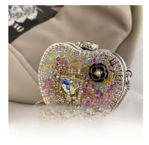 Close-up of heart-shaped clutch featuring colorful beads, rhinestones and black camellia