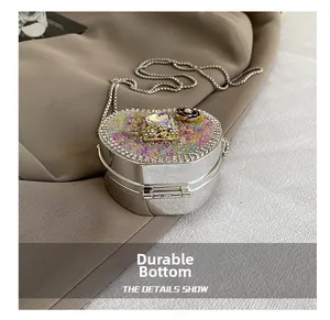 Detail of silver heart bag featuring colorful rhinestones and a durable bottom base