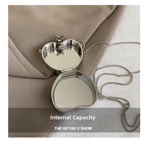 Macro view of heart-shaped mini bag interior with polished silver mirror finish