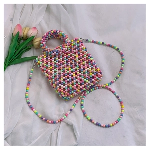 Detail of a handmade colorful beaded crossbody bag with candy-colored macaron beads