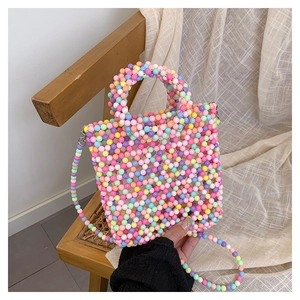 Detailed macro view of vibrant colorful handmade beaded handbag with intricate weaving