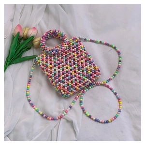 Detail view of handmade multi-color beaded mini handbag with rainbow candy-colored beads
