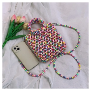 Mini macaron beaded handbag with shoulder strap and phone for size comparison