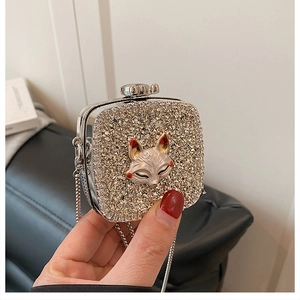 Close-up of luxury square evening clutch with sparkling rhinestones and 3D fox embellishment