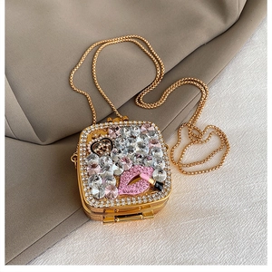 Detailed view of the rhinestone evening clutch bag with lipstick and lips crystal patterns