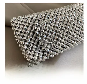 Detailed macro view of silver acrylic beads woven texture on a fashion underarm bag