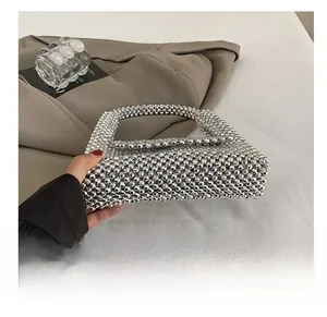 Detail of silver beaded handbag showing the woven acrylic pearls and durable base construction