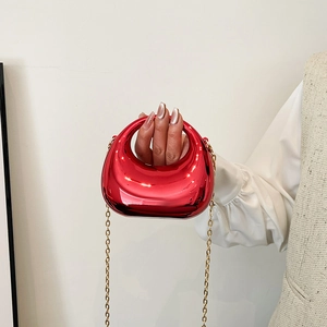 Glossy red acrylic mini crossbody bag with golden chain strap and minimalist arc design