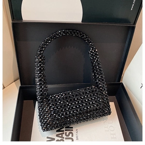 Close-up of black acrylic beaded handbag in a premium gift box with luxury details