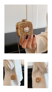 Detailed view of luxury gold rhinestone mini bag featuring a crystal fox head accent