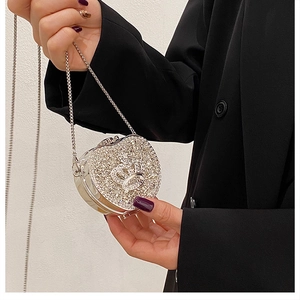 Close-up of luxury mini silver heart evening bag with crystal rhinestones and crown detail