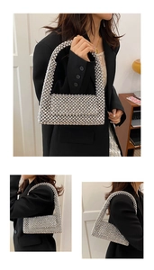 Detailed view of a silver beaded shoulder bag with metallic weave and acrylic pearls