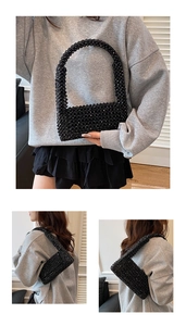 Detail of handmade black acrylic beaded woven bag with stylish integrated round handle