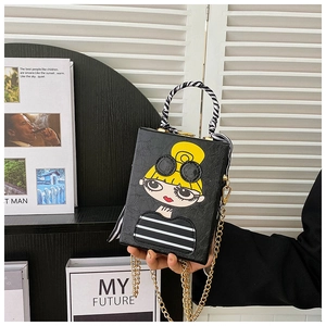 Detail of trendy box bag with cartoon girl print, zebra scarf handle and gold chain strap