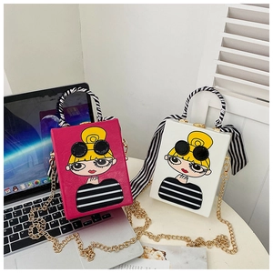 Detail of trendy cartoon square box handbags with metal chain and silk-wrapped handle