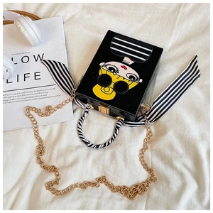 Detail of crossbody box bag with cartoon girl print and striped ribbon handle