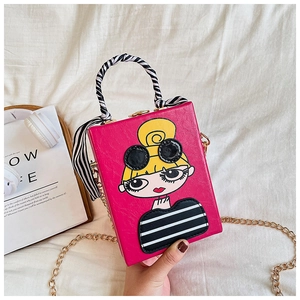 Detail of rose red box bag featuring fashion girl print and silk scarf handle decor
