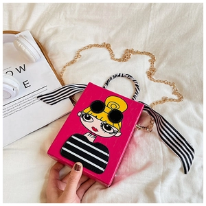 Detail of pink crossbody box bag with cartoon girl print and striped ribbon handle