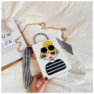 Detail of white crossbody bag with fashion cartoon girl print and zebra stripe handle