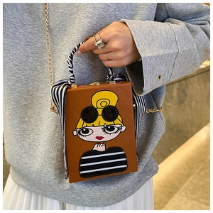 Chic brown box bag with cartoon girl print and stylish scarf handle detail on model