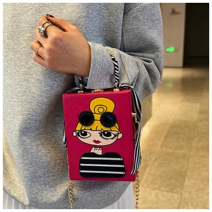 Detail of fuchsia box bag with cartoon girl print and silk scarf wrapped handle